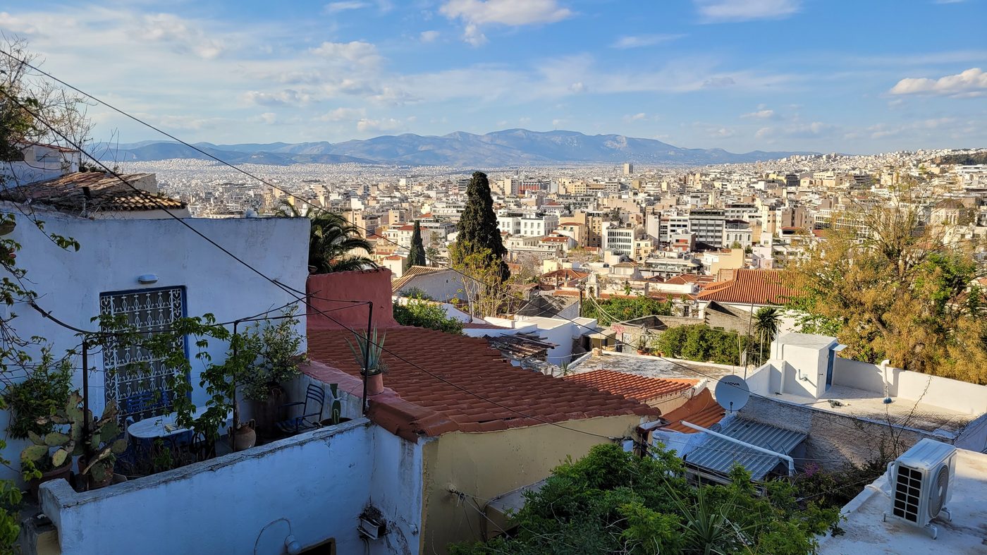 The whitewashed houses and narrow lanes of the Anafiotika neighborhood nestled on the slopes beneath the Acropolis, a hidden gem in the heart of Athens