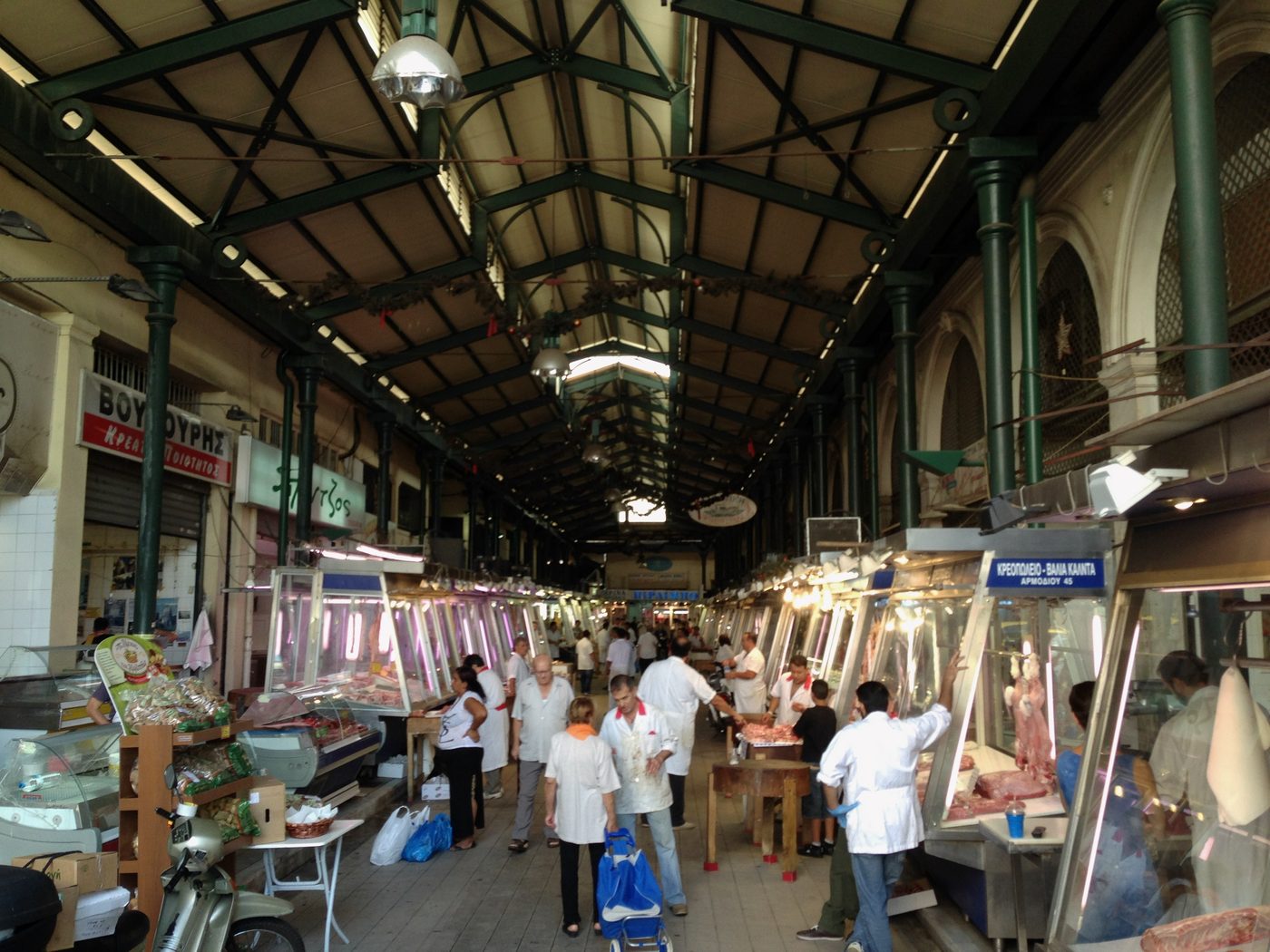 The bustling interior of the Varvakios Central Market in Athens with vendors and colorful produce displays
