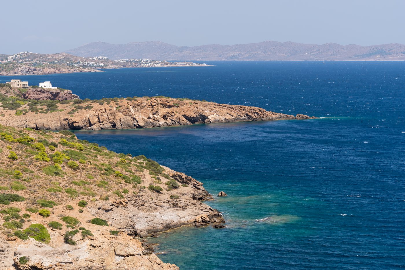 Turquoise Aegean sea and rocky coastline as seen from Cape Sounion, Greece