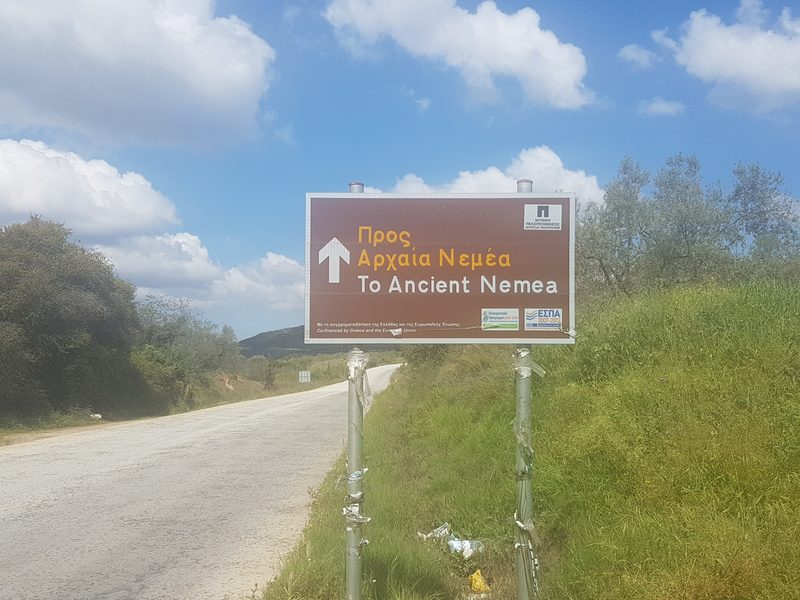 A road sign pointing the way to Ancient Nemea on the approach road