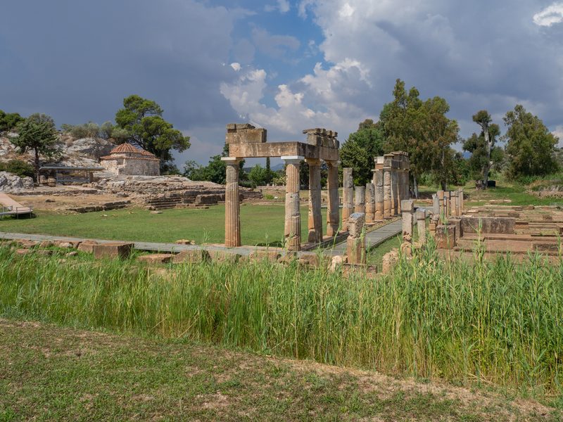 Archaeological site of Brauron with the Temple of Artemis foundations and the small white chapel of Saint George amid green landscape