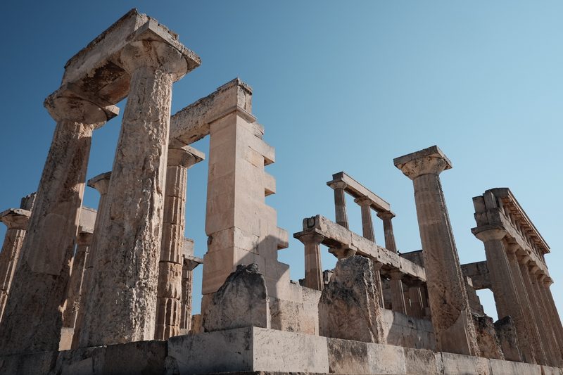 The Temple of Aphaia on Aegina island, Greece, with its ancient Doric columns standing against a clear sky