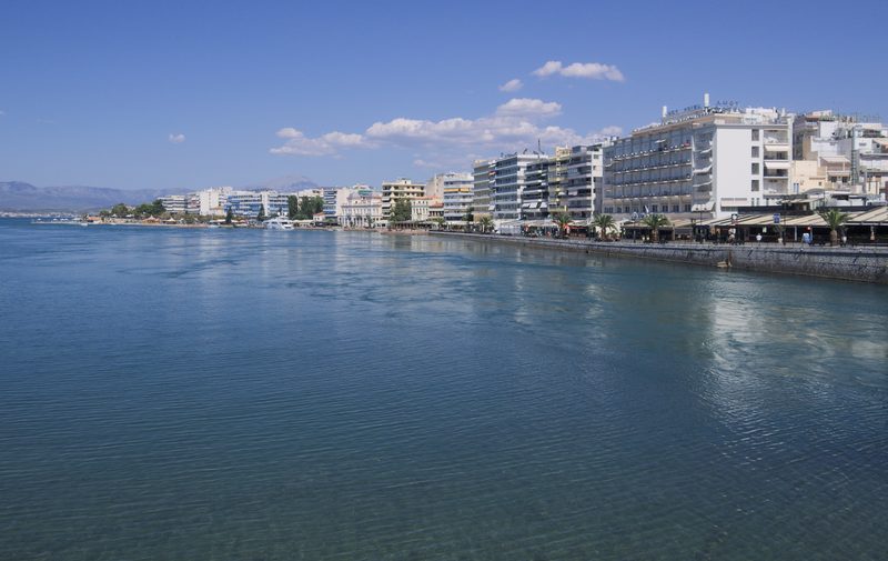 Aerial view of Chalkida waterfront and the narrow Euripus Strait separating Evia island from the Greek mainland, with the tidal current visible in the channel