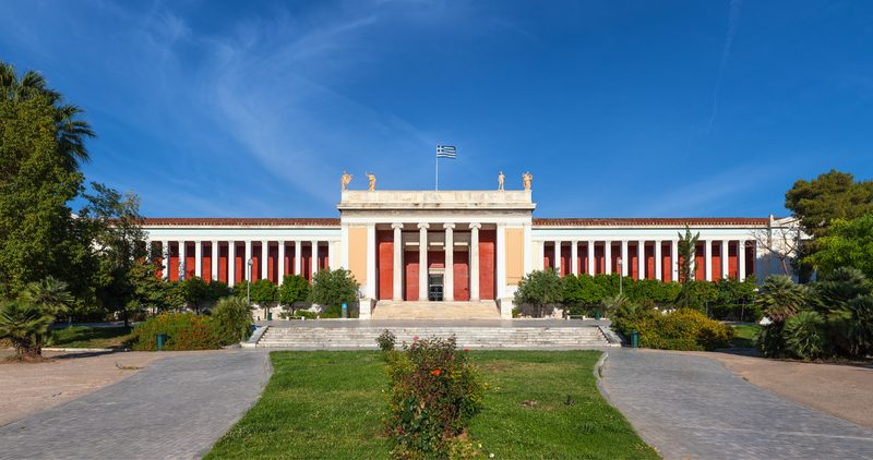 The grand neoclassical facade of the National Archaeological Museum of Athens with its columned portico and symmetrical wings