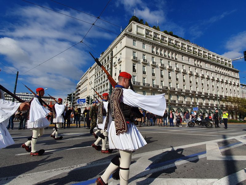 Evzones guards in traditional kilted uniform marching past the Grande Bretagne hotel near Syntagma Square