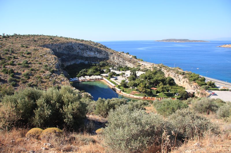Lake Vouliagmeni thermal lake with clear water, limestone cliffs, and surrounding greenery
