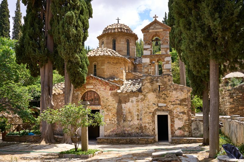 The stone Byzantine church of Kaisariani Monastery surrounded by trees on the slopes of Mount Hymettus