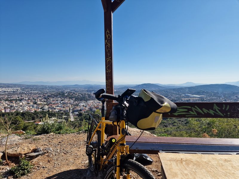 A trailside viewpoint marker on Mount Hymettus overlooking a suburb of Athens