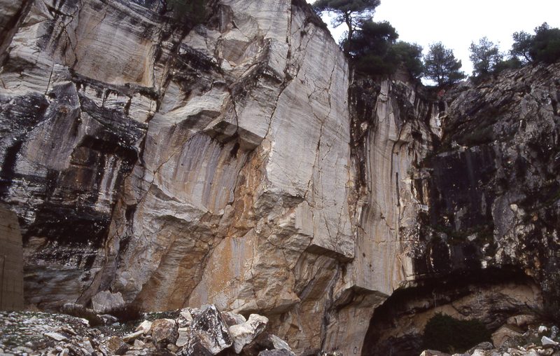 Exposed white marble cliff face of the ancient Spilia quarry on Mount Penteli, the source of Pentelic marble used to build the Parthenon
