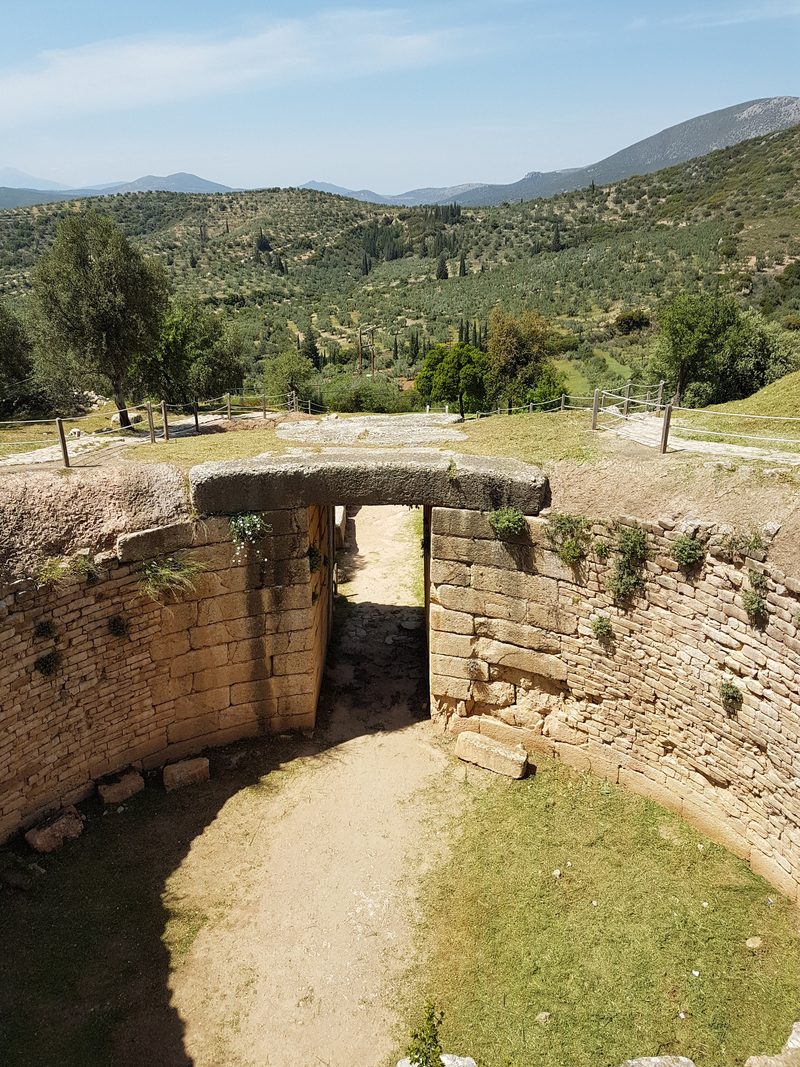 The long stone dromos passage leading to the doorway of the Treasury of Atreus beehive tomb at Mycenae