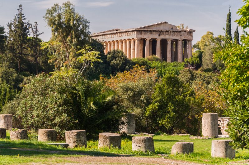 The Temple of Hephaestus rising above the Ancient Agora of Athens, its Doric columns and pediment intact against a blue sky