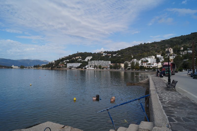 Askeli Beach on Poros with turquoise water, sandy shoreline, and pine-covered hills behind