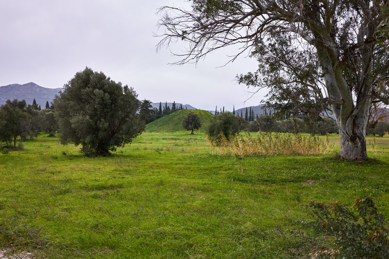The burial mound of the Athenian soldiers on the plain of Marathon, Greece, a grassy hill rising from the flat battlefield