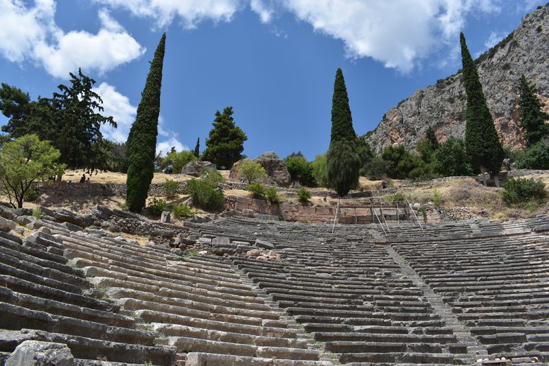 Ancient theatre of Delphi with stone seating rows overlooking the valley and mountains of central Greece