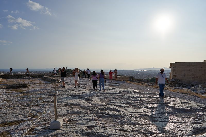 Tourists walking on the polished marble pathways of the Acropolis in Athens