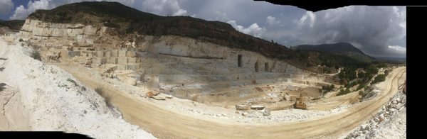 The ancient Pentelic marble quarry at Dionyssos with exposed white marble face and surrounding vegetation