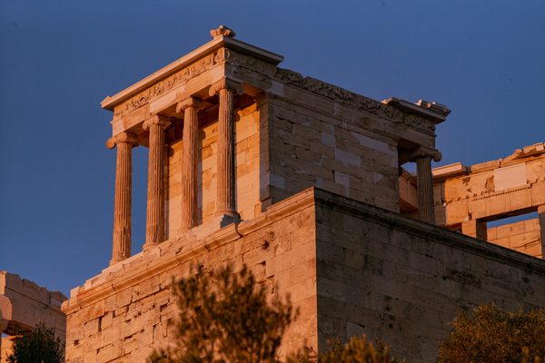 The Acropolis and Parthenon illuminated by warm sunset light over Athens